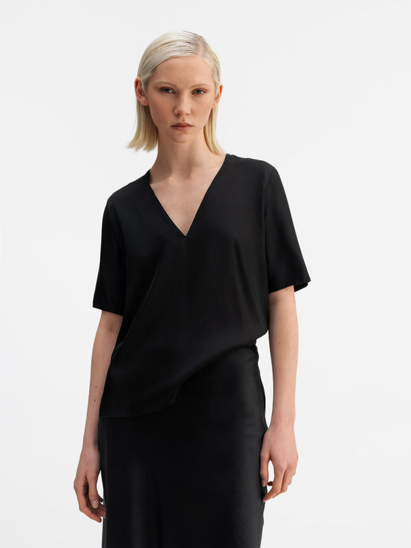 Model wearing Ahlvar Gallery Yoli v-neck silk blouse black