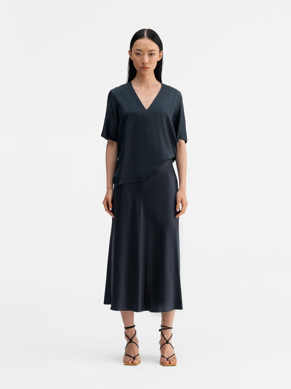 Model wearing Ahlvar Gallery Yoli v-neck silk blouse blue grey
