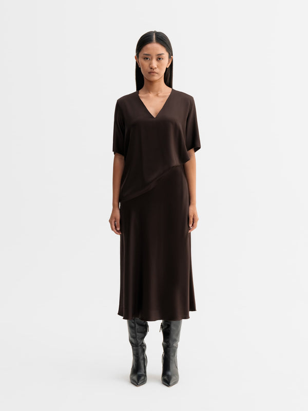 Model wearing Ahlvar Gallery Yoli v-neck silk blouse in Dark brown