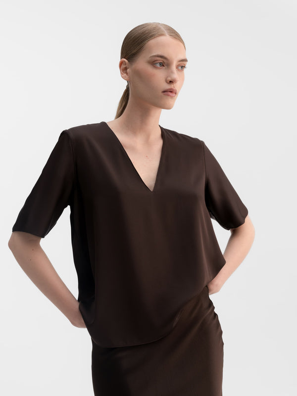 Model wearing Ahlvar Gallery Yoli v-neck silk blouse in Dark brown