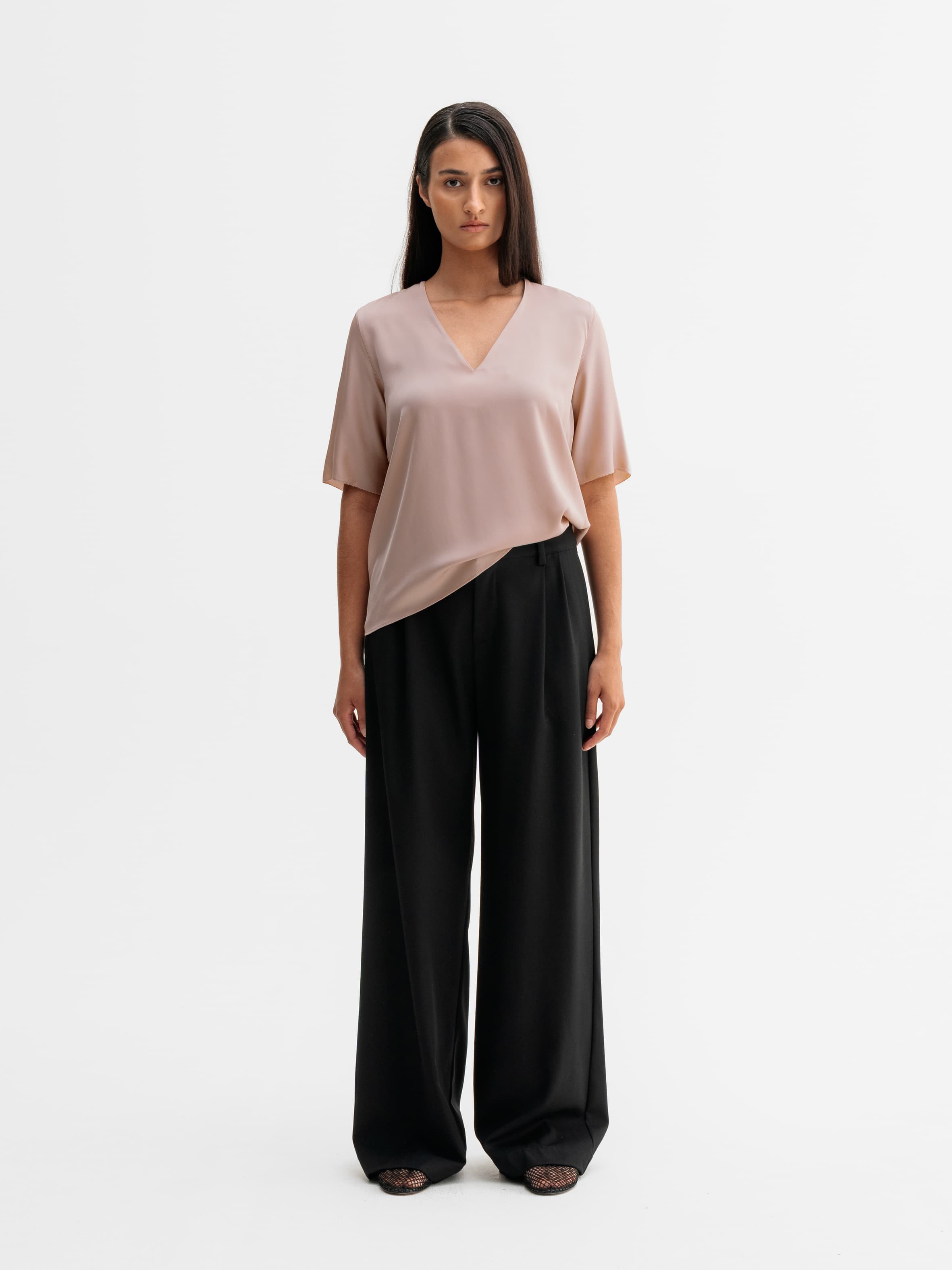 Model wearing Ahlvar Gallery Yoli v-neck silk blouse in Dusty pink
