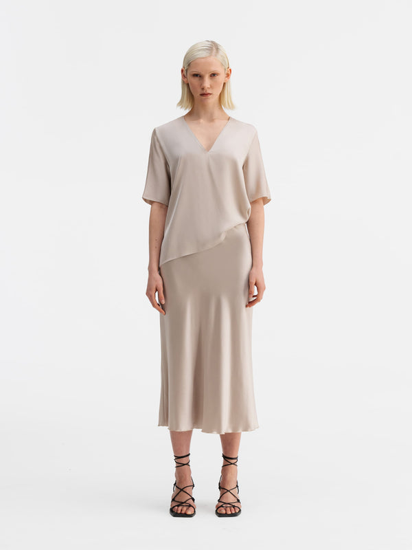 Model wearing Ahlvar Gallery Yoli v-neck silk blouse greige